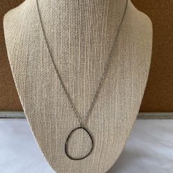 Silver colored chain might be silver and metal pendant necklace needs cleaning looks a little tarnished