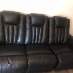 Black Leather Couch With A Small Tear 