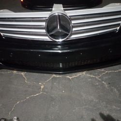 2006-2009 Mercedes CLS Series Complete Front Bumper With Grills And Emblem And Fog Lights With Accessories And Parking Assistance Sensors OEM.