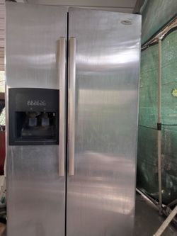 Large stainless side by side Whirlpool refrigerator freezer