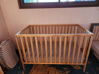 Wooden crib with mattress