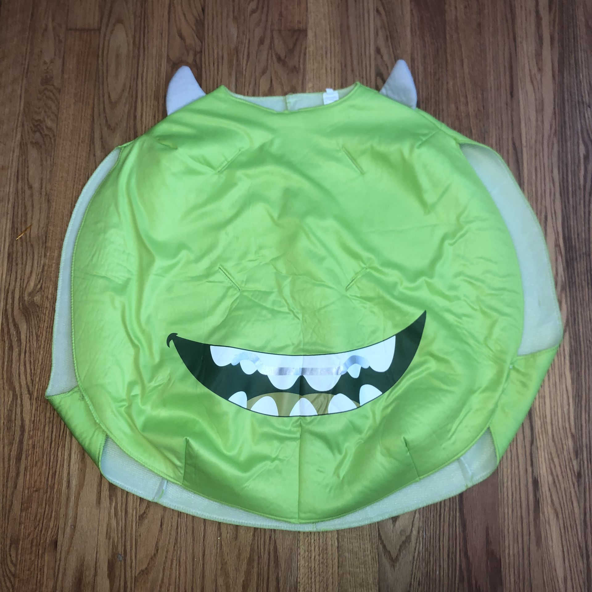 Kids Monsters Inc. costume. It slips over top of clothes so it can fit a large range of sizes. I’d say from an 8 up