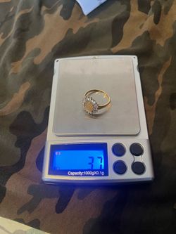 Solid 14YG ring with natural Ethiopian opal surrounded by natural white topaz 3.7 grams size 8