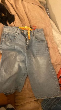 light blue jorts with wings on the back