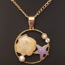 NEW Betsey Johnson Necklace.  Gold and the Pendant has Enameled Beige Clam Shell, Purple Starfish, 2 Pearls and a Clear Rhinestones.  Absolutely Beaut
