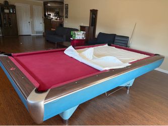 8ft pool table with sticks and balls