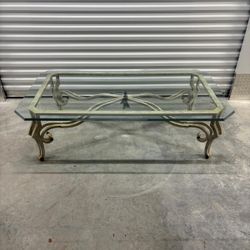 Iron base and glass coffee table has a  small chip on under  the glass. 60 “ wide , 33” depth , 18 “high … $50