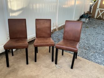Three Modern leather dinning chairs, by Brayden studio, color brown,, legs color black (all for $60)