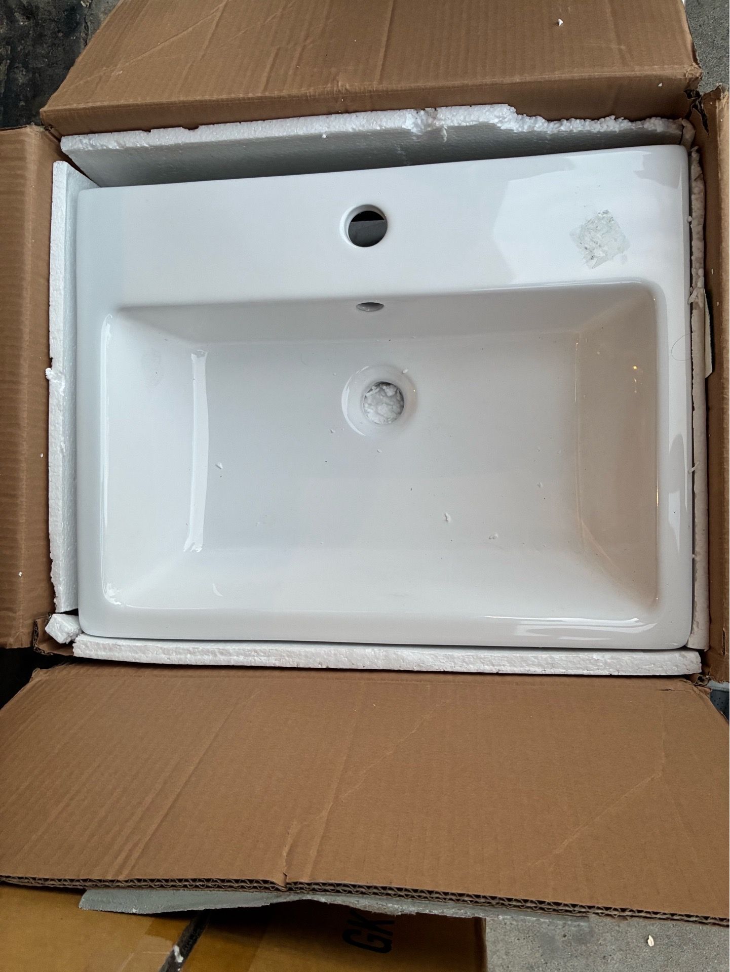 New white rectangular ceramic bathroom basin with a single faucet hole,
