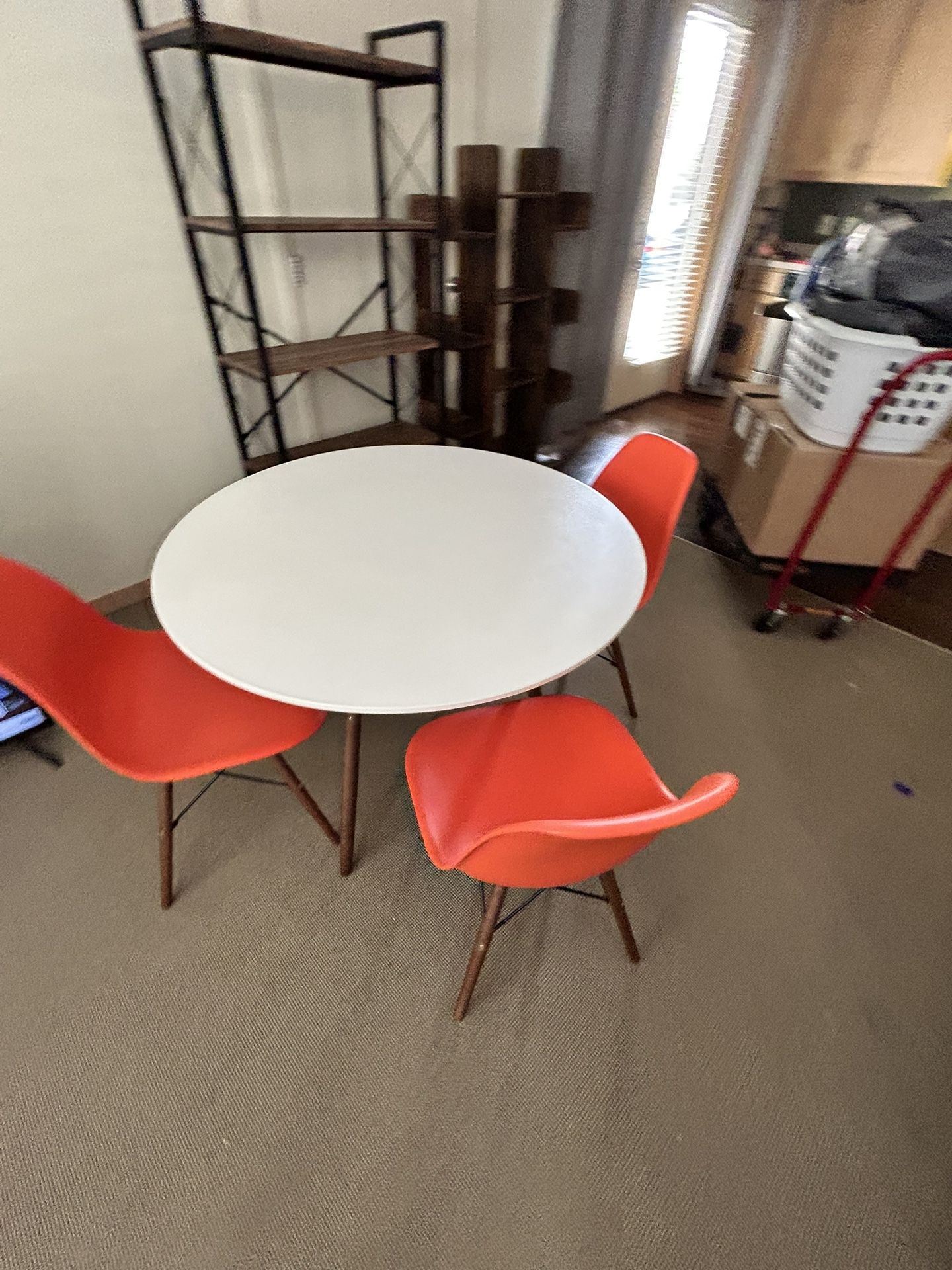 White Wood Circular Table With 4 Orange Chairs