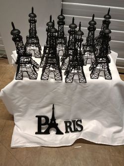 Eiffel towers statue's and paris sign.