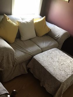 Love seat and ottoman with slip covers
