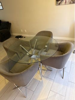 Grey 4-chair dining set with a glass table
