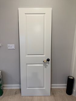 White 2-Panel Interior Door with Black Knob