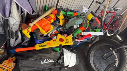 Two buckets full of nerf and toy weapons