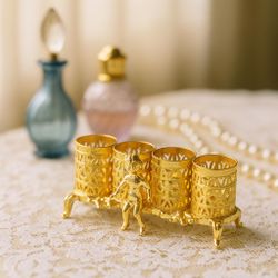 SF© 1960s Gold-Tone Rococo Lipstick Holder With Cherub, 4x1.5”