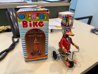Duck on bike metal toy