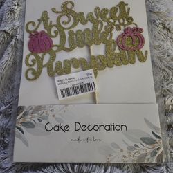 Sparkling cake topper that reads 'A Sweet Little Pumpkin' in gold glitter. Features pink glitter pumpkin accents for a festive look. Ready-to-use 