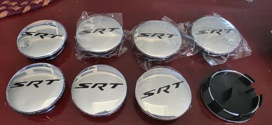 8 total SRT 63mm center caps new but all have tiny dents.  I have undented ones $50 a set