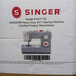 New Heavy Duty Singer Sewing Machine With Cutting Board And A Large Roll Of Fabric