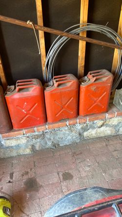 Five old 5 gallon red vintage metal gas tank tanks