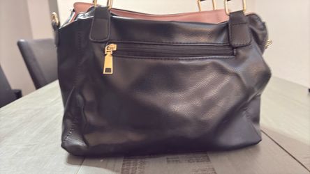 Black leather fashion handbag with zipper closure and shoulder handle