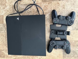 PS4 (500 megabytes) with two controllers and a dual stand