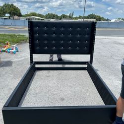Black upholstered queen bed