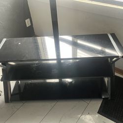 black metal and tempered glass TV stand with a mount. 