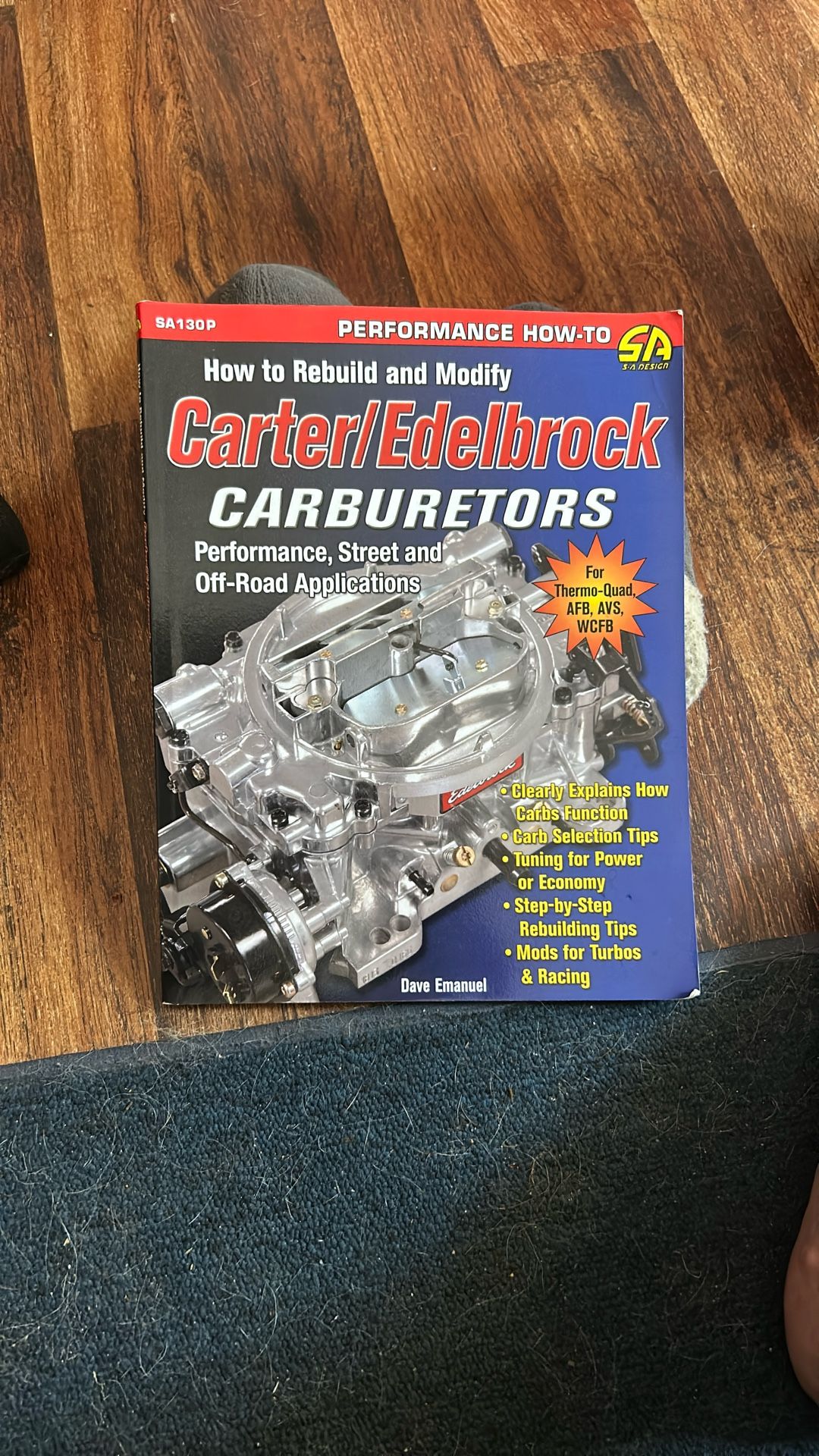 The image displays a book titled "How to Rebuild and Modify Carter/Edelbrock CARBURETORS" by Dave Emanuel.