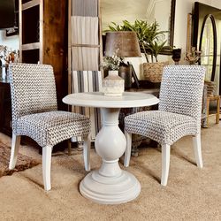 White round table and 2 rattan chairs
