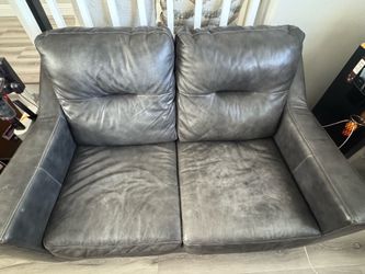Dark Gray faux leather two-seater loveseat ( Used )