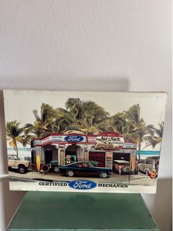 Vintage-style wall art featuring a Ford garage scene.