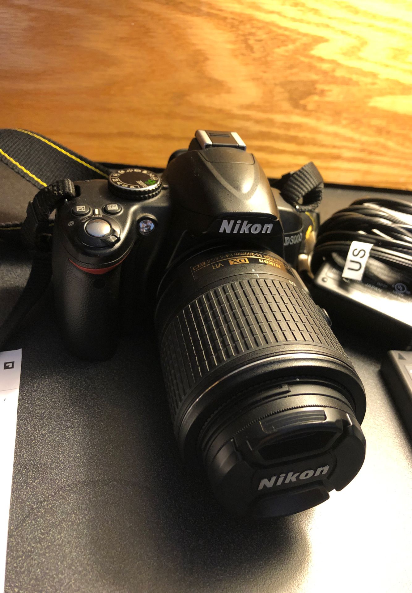 Nikon D3000 with 55-200mm lens, 2 sd cards, charger, lens hood, 3 batteries