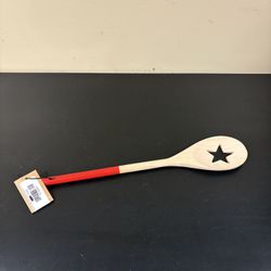 acacia wood spoon with cut oil and a star design