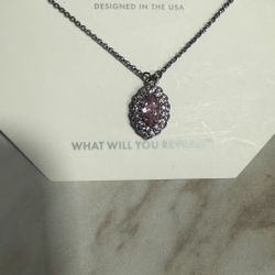 “a necklace with a pendant