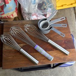 Whisks and plastic measuring cups