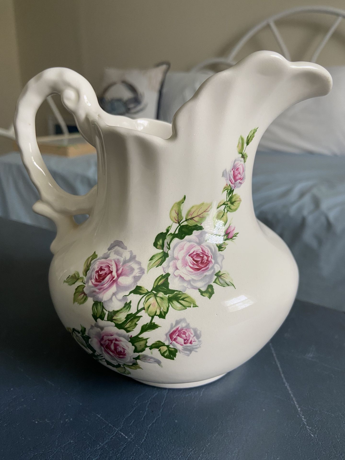 Pitcher With A Flower Design That Can Be Used As A Vase