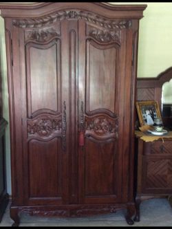 Antique Armoire has beautiful ornate carvings.