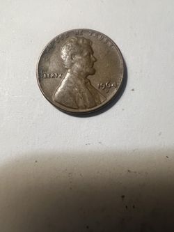 1964-D Lincoln Penny (L) in Liberty against the Rim.