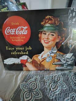 Reproduction coca cola sign. From the 1940s when women worked. Men were at war