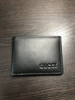 Gucci engraved soft rolled leather bifold wallet