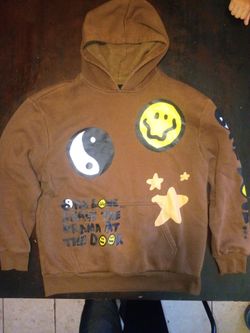 Large brown smiley face hoodie pacson