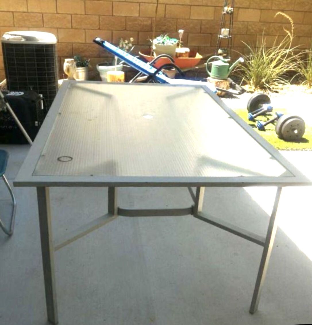 Metal glass top outdoor table. $30.00