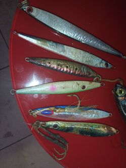Vertical jigs used primarily for deep water fishing from a boat rather than casting from a pier. The lot contains several assorted weighted lures of v