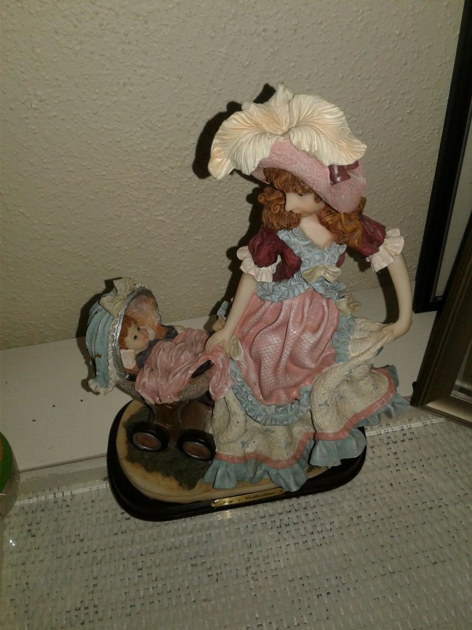 Figurine with baby in stroller