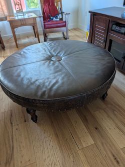 Large round leather ottoman