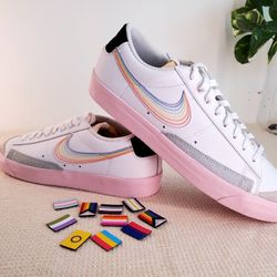Nike Blazer Low 77 "Be True" sneakers with accessories.