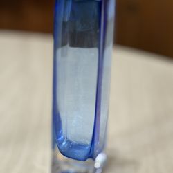 Elegant tall blue glass vase with a sleek rectangular shape and thick clear base. Beautiful rich cobalt-to-clear glass tones that catch the light nice