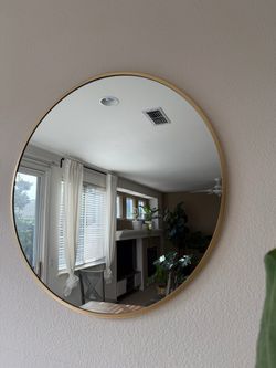 Round mirror with gold trim